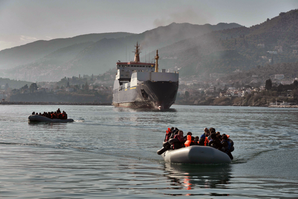 Refugees and migrants arrive on a dinghy at the Port of Mytilene, on the Greek island of Lesbos, after crossing the Aegean sea from Turkey, on Thursday (AFP photo)